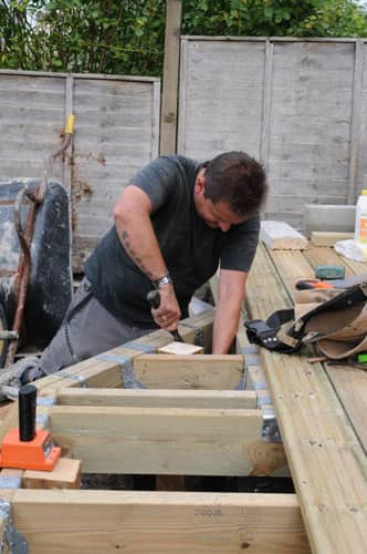 man cutting decking - LSK Building Westbury, Warminster and Trowbridge