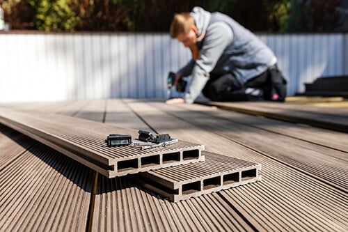 Man laying a wood deck - LSK Building Westbury, Warminster and Trowbridge