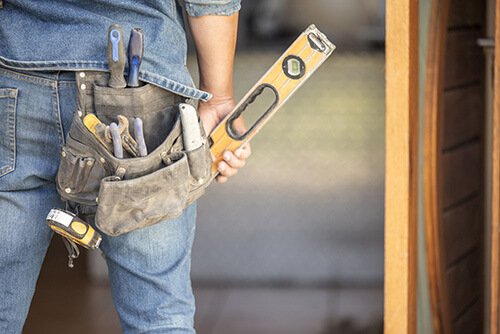 Builder wearing a tool belt - LSK Building Westbury, Warminster and Trowbridge